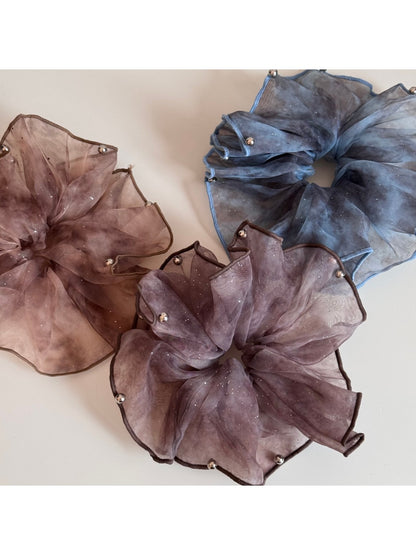 Pink sparkly tulle scrunchie styled on a wrist as a bracelet