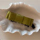 Beau bow hair clip held in hand to show size and scale