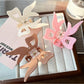 Beau acrylic bow-shaped claw clip in translucent beige on white background