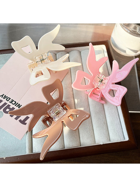 Beau acrylic bow-shaped claw clip in translucent beige on white background
