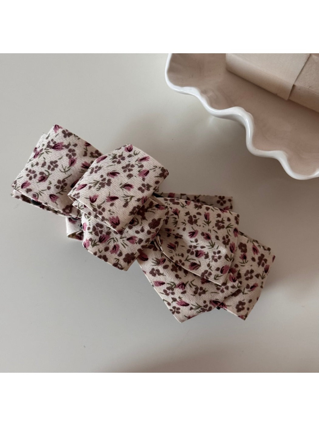 Back view of Beau floral bow hair clip showing metal clip mechanism