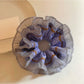 Close-up of Gifty scrunchie showing delicate lace trim and polka dot pattern
