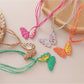 Earedge raffia butterfly pendant necklace on a white background