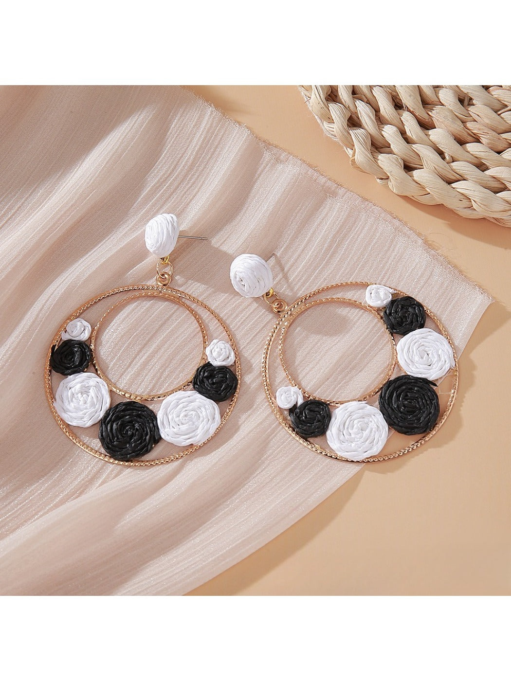 Sweet Raffia Circle Stud Earrings worn on a model's ear