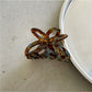 Beau Misty Acetate Butterfly Hair Clip resting on a wooden surface