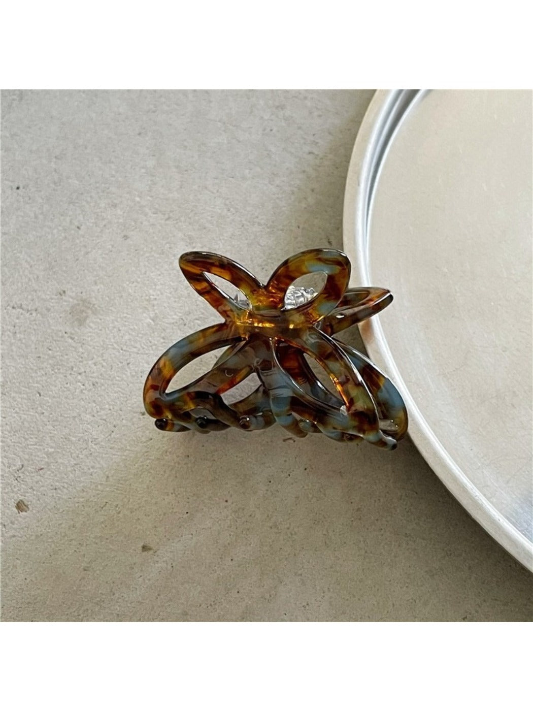 Beau Misty Acetate Butterfly Hair Clip resting on a wooden surface