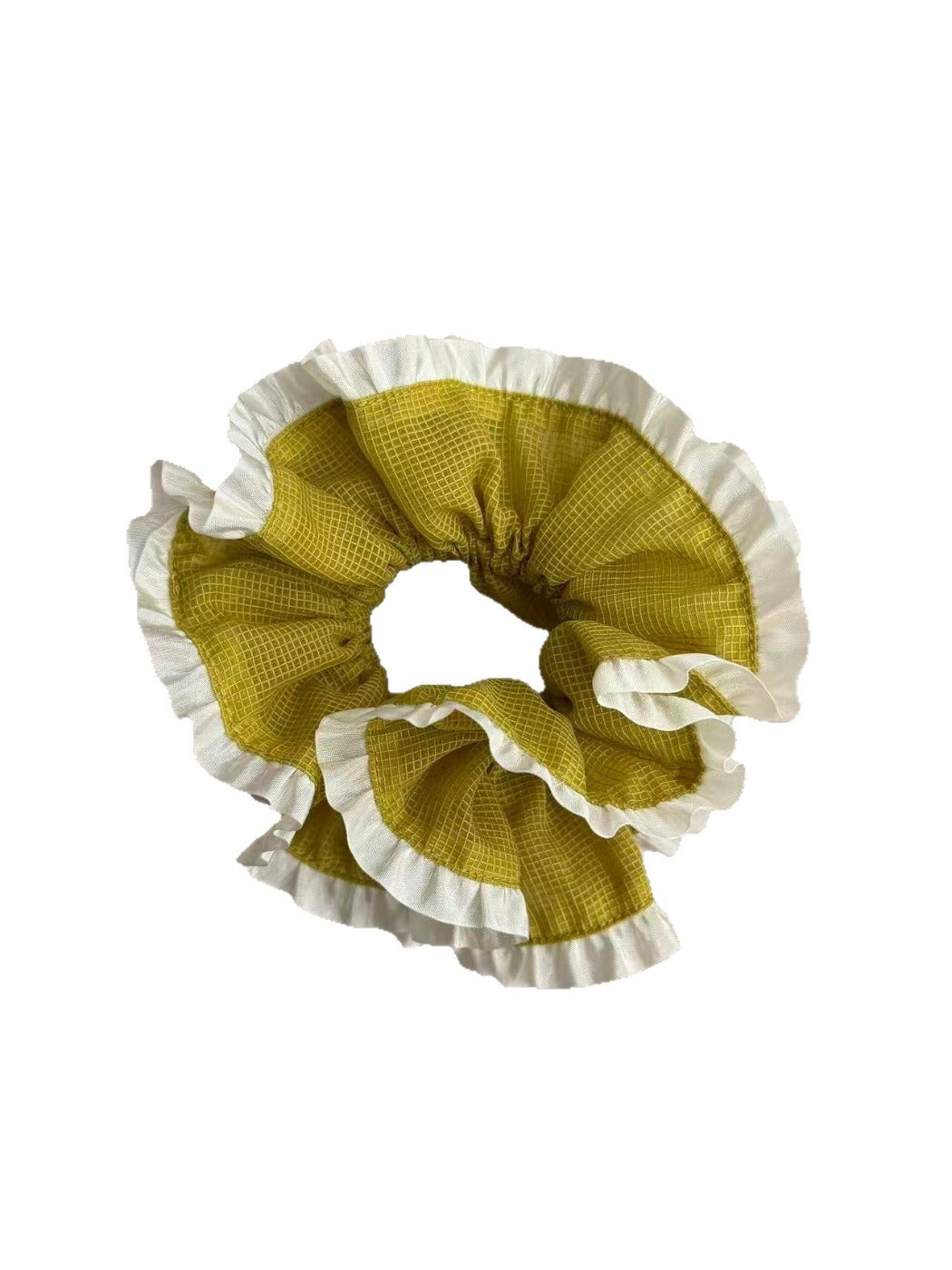 Green plaid scrunchie worn on a wrist showing white trim detail