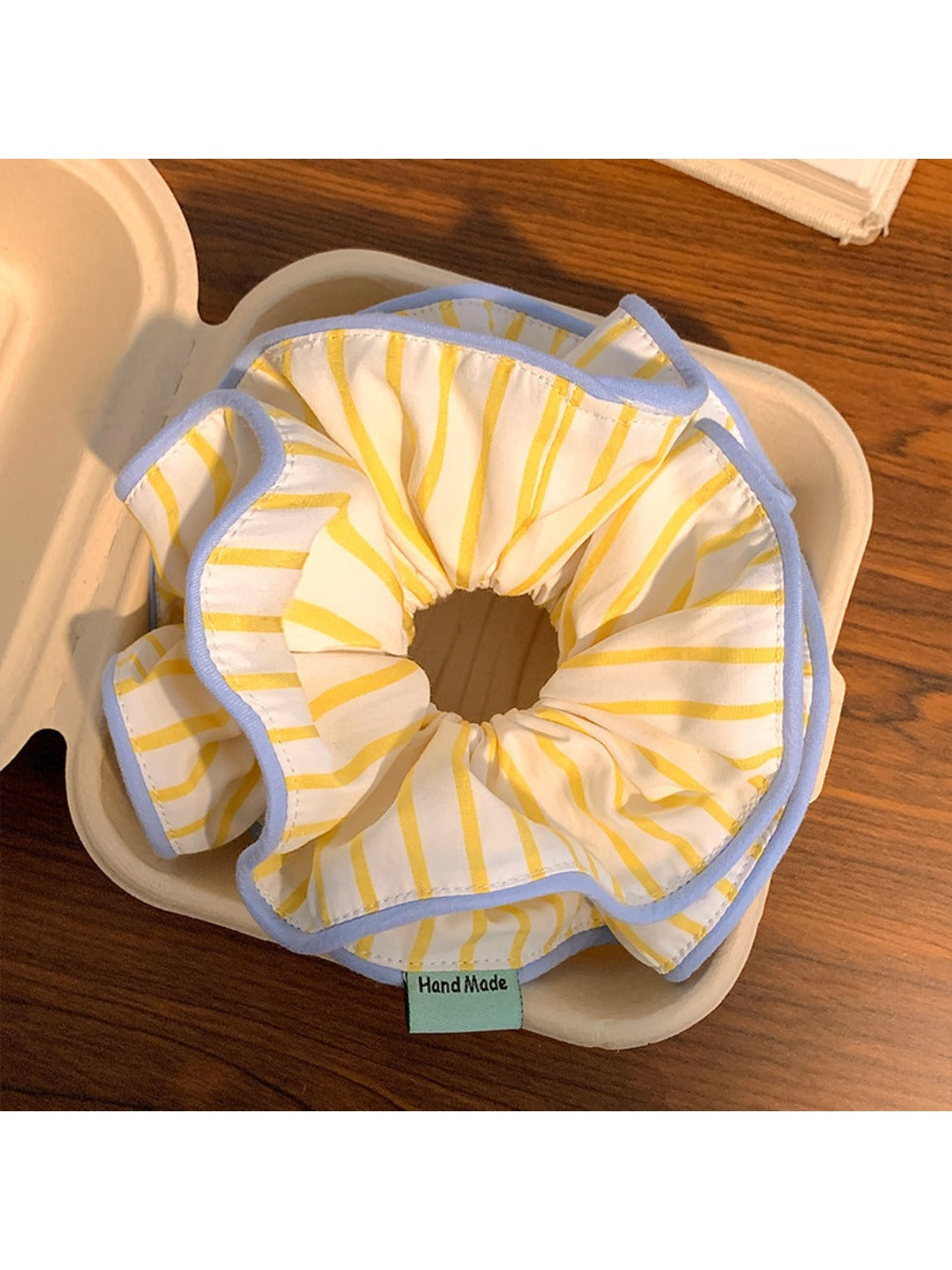 Close-up of yellow striped fabric texture on hair scrunchie