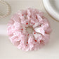 Close-up of a sweet cute pink scrunchie made of soft fabric