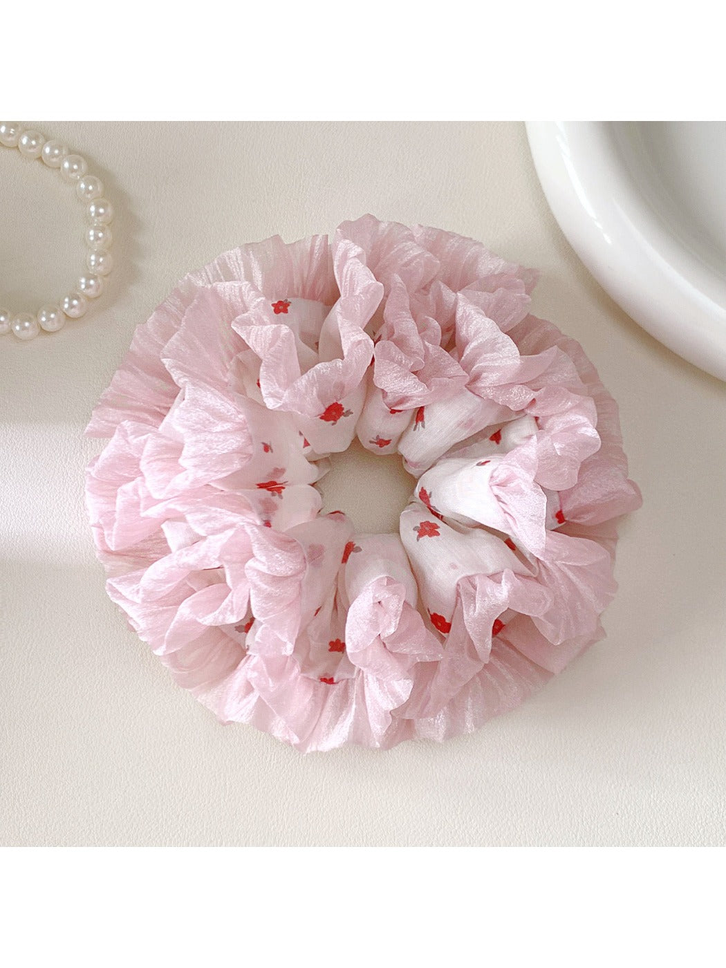 Close-up of a sweet cute pink scrunchie made of soft fabric