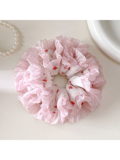 Close-up of a sweet cute pink scrunchie made of soft fabric