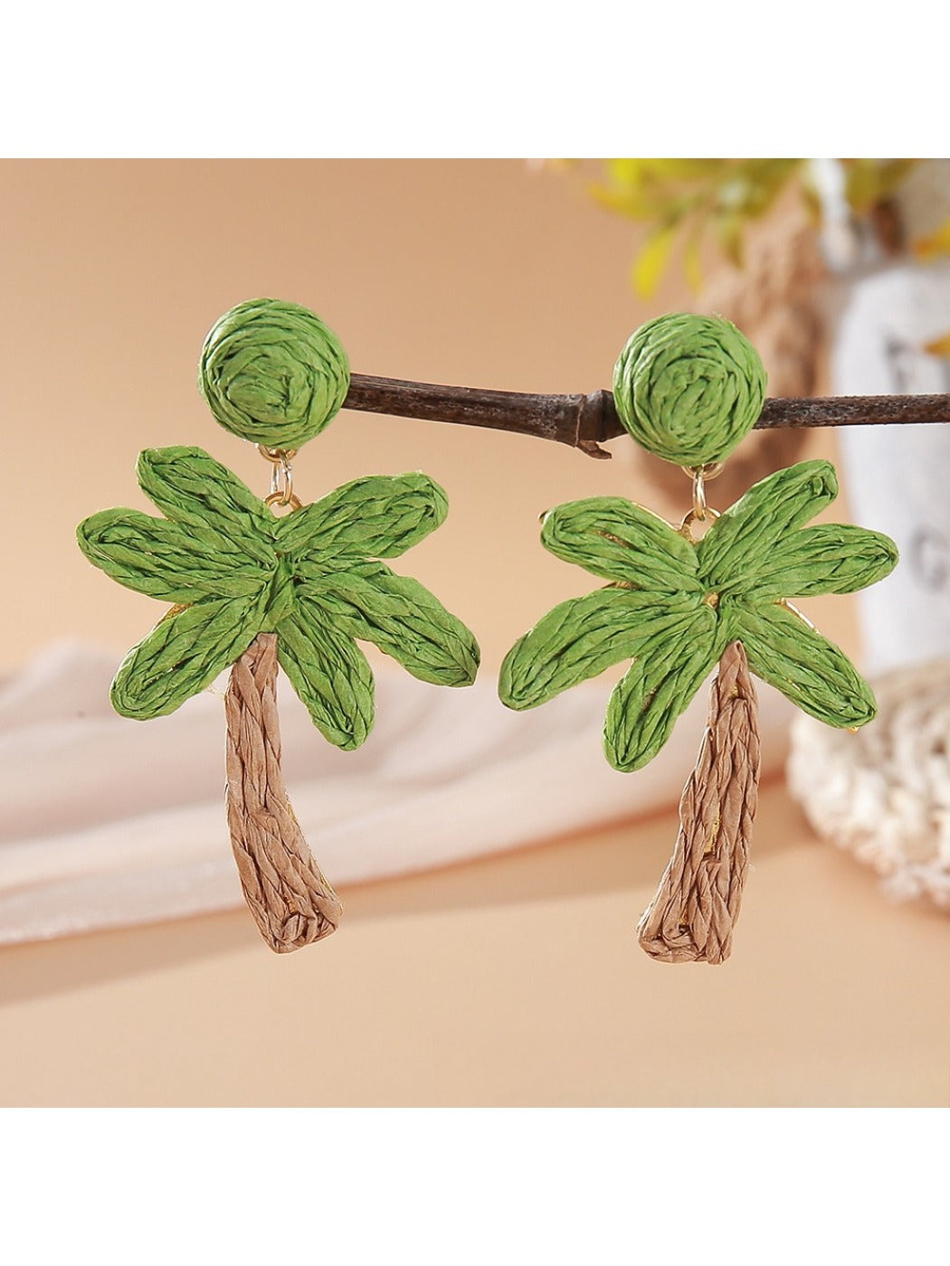 Side view of Earedge raffia palm tree earrings showing woven texture