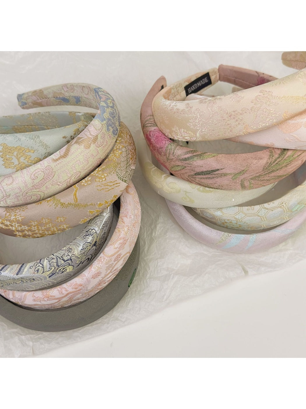 Close-up of Gifty fabric embroidered flower headband with pink and white flowers