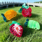 Beau acetate claw clip shaped like a red strawberry fruit with green leaves