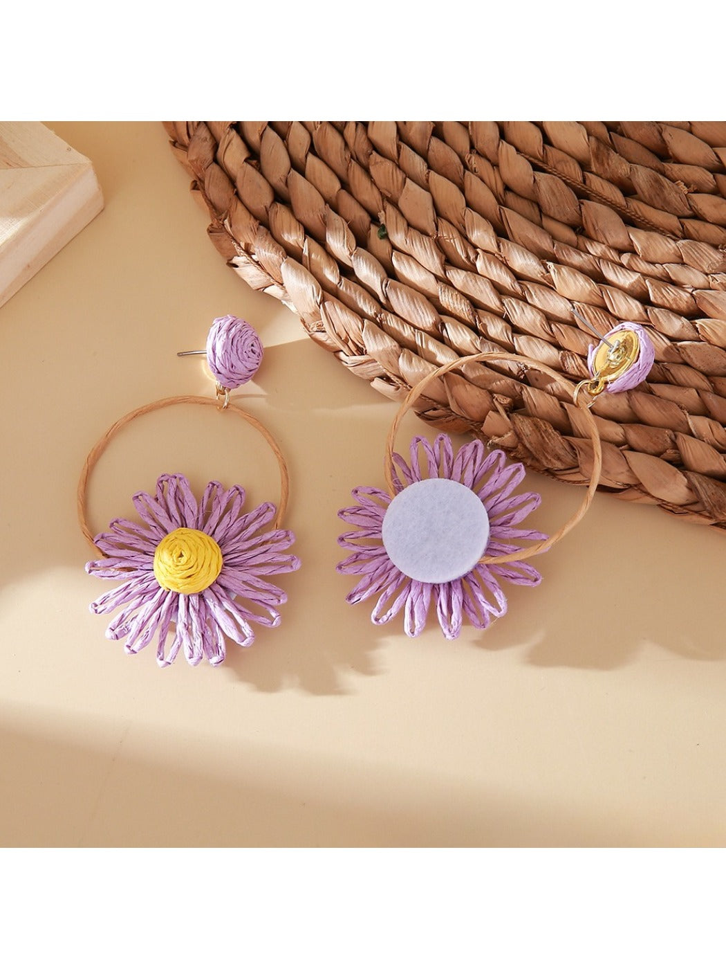 Side view of Earedge raffia circle flower earrings showing woven texture