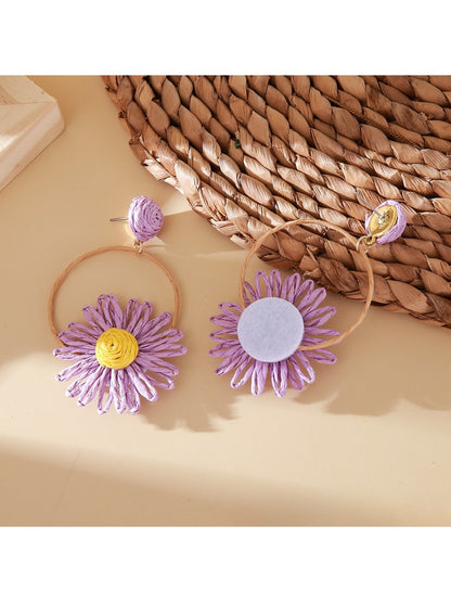 Side view of Earedge raffia circle flower earrings showing woven texture