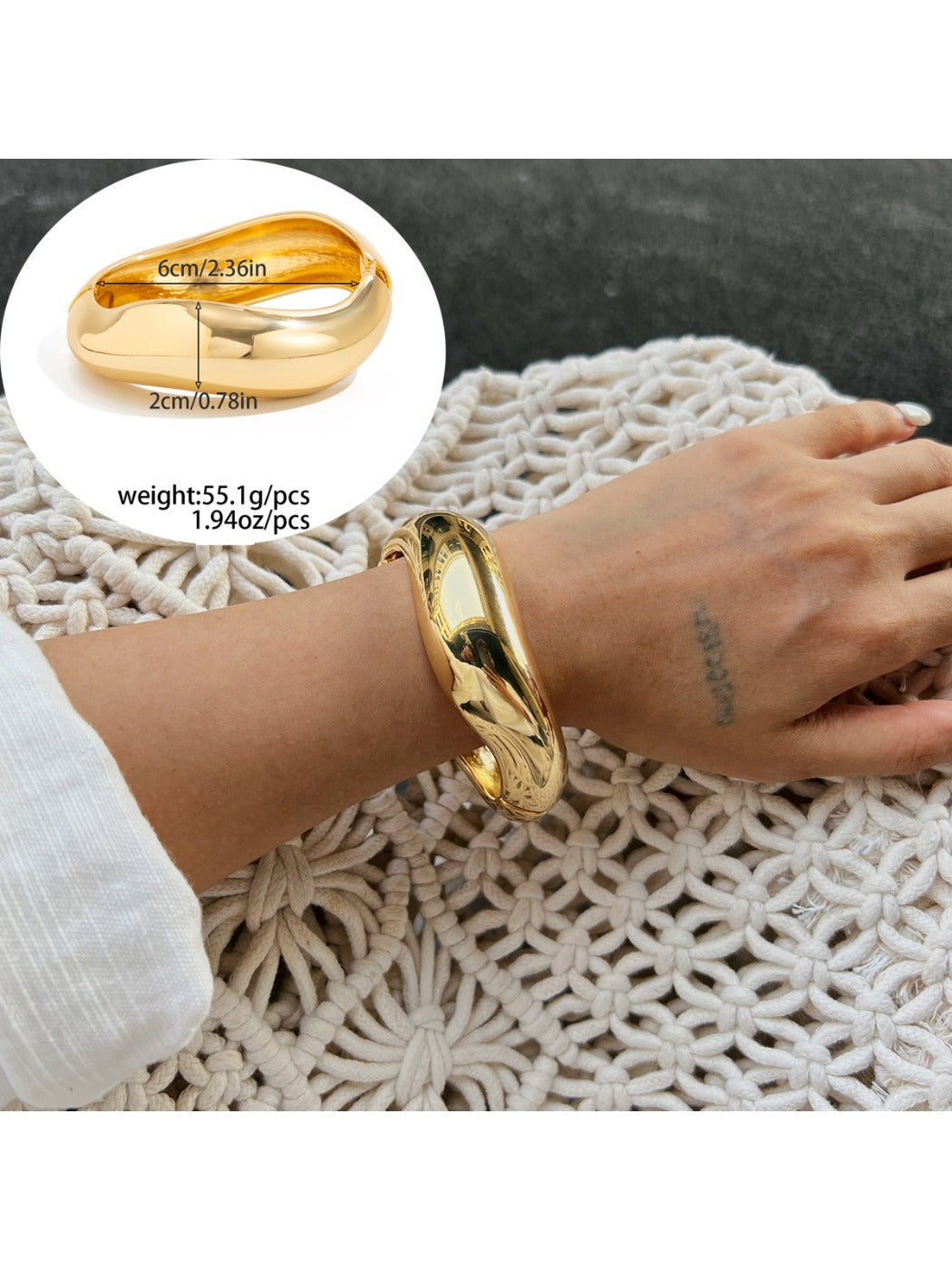 Lovra silver wide fit bracelet resting on a neutral fabric background