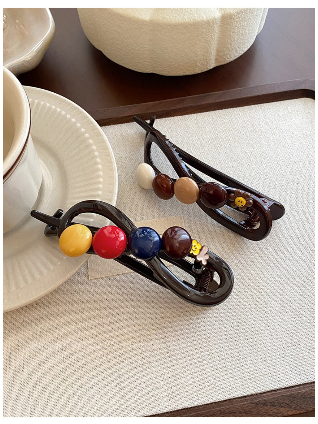 Close-up of Beau hair clip showing round colorful beads on gold metal bar
