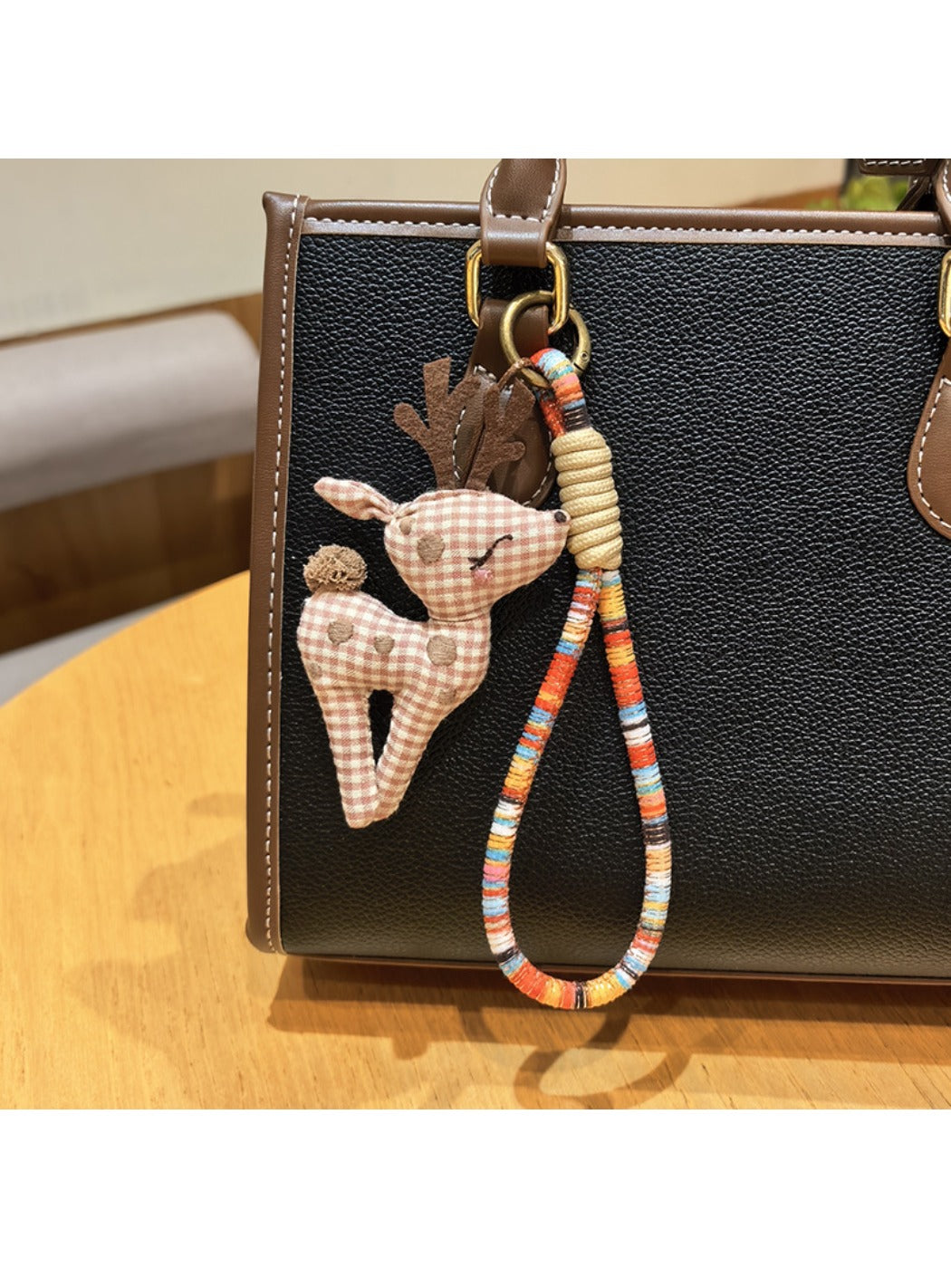 Keypus deer charm keychain displayed in a gift box with soft padding