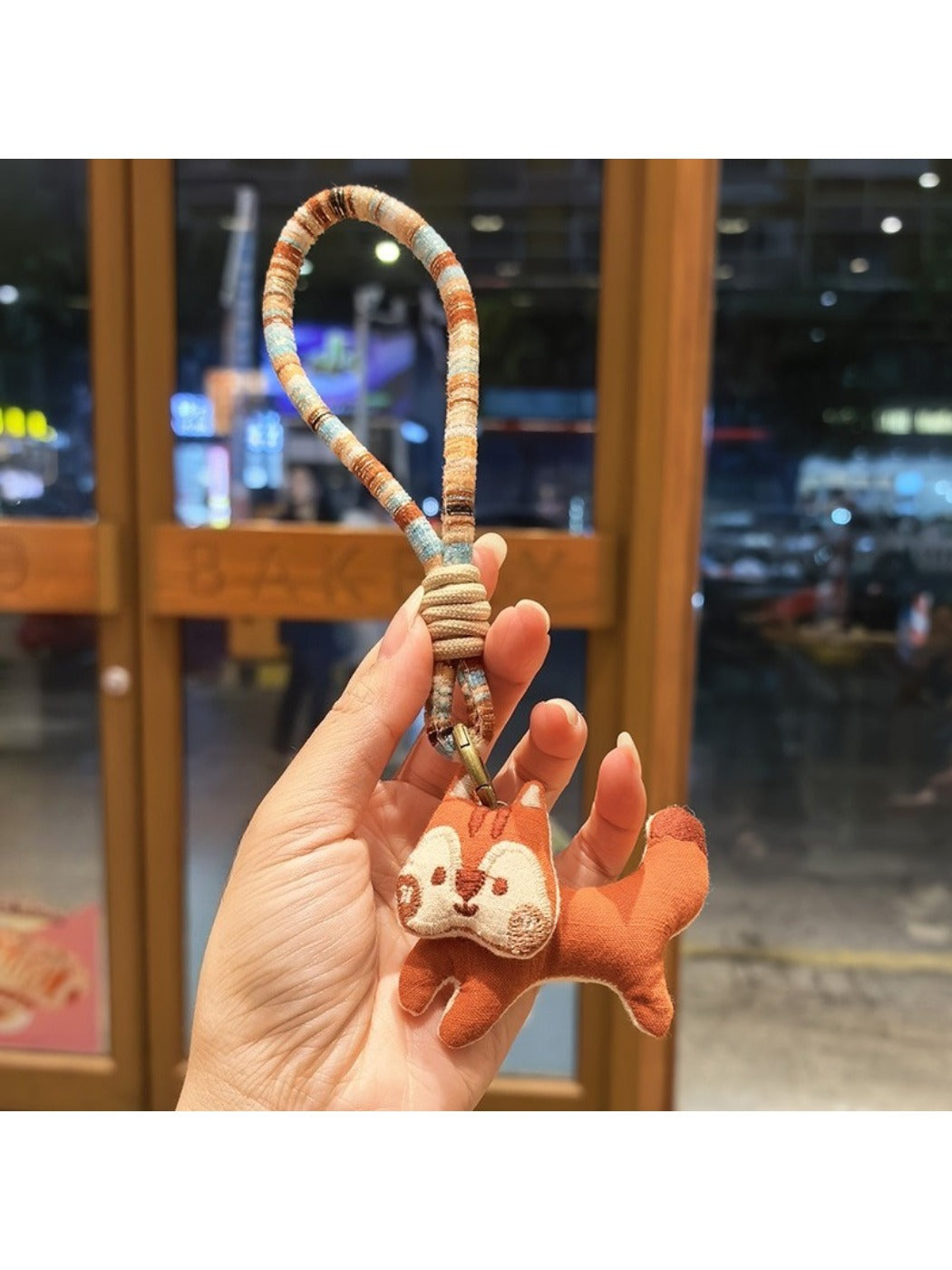 Keypus squirrel charm keychain photographed with soft natural lighting