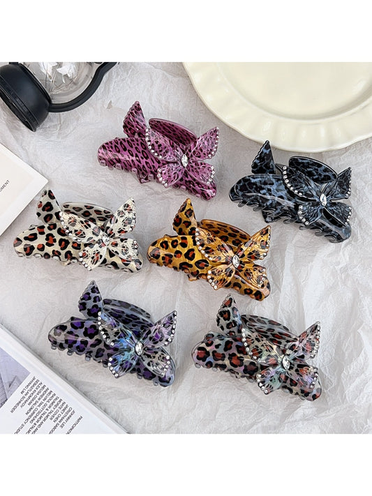 Close-up of Beau leopard print claw clip with butterfly decoration on a white background