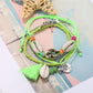 Detailed shot of silver charms and colorful beads on Lovra Bohemian bracelet