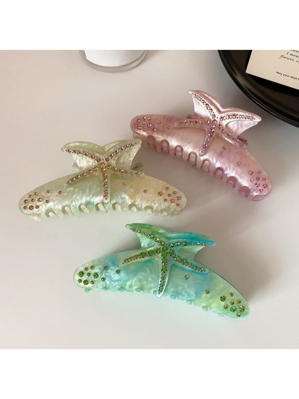 Close-up of the crescent-shaped hair claw clip showing vibrant multicolor design