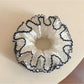 Close-up of a sweet four tier ruffled scrunchie in pastel colors
