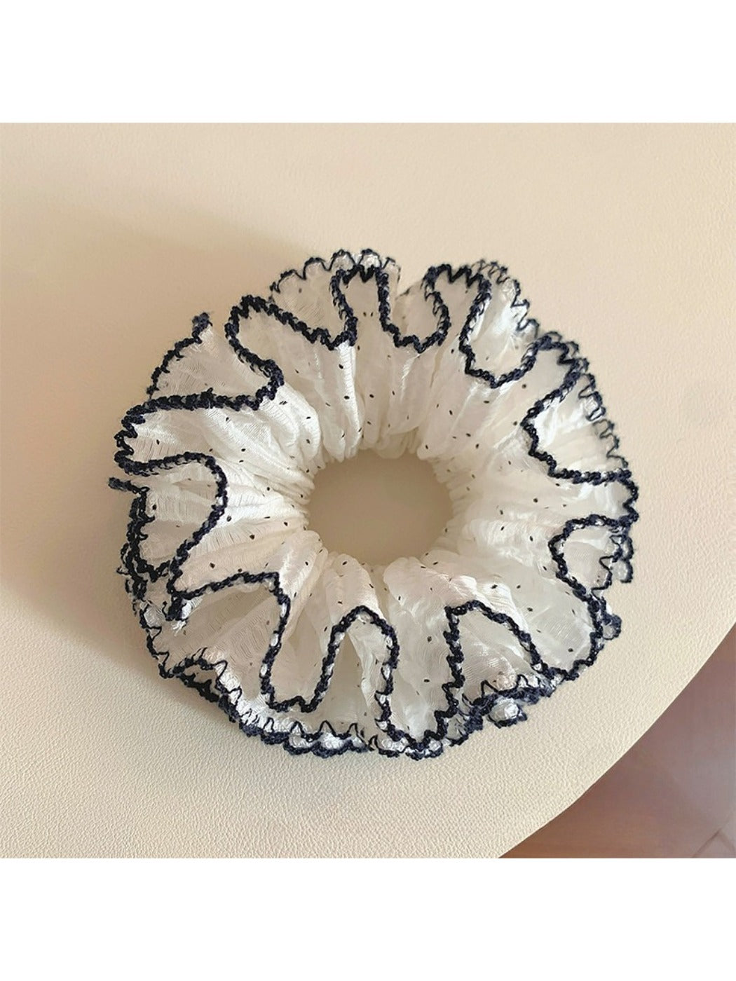 Close-up of a sweet four tier ruffled scrunchie in pastel colors