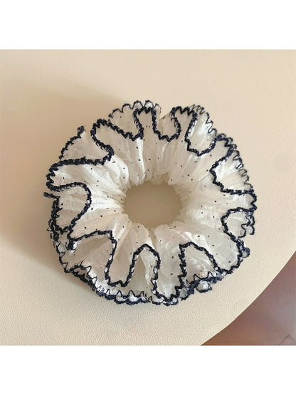 Close-up of a sweet four tier ruffled scrunchie in pastel colors