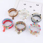 Lovra stackable bracelet worn on wrist with multiple colorful beads
