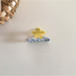 Beau acetate flower shaped hair clip shown from an angled perspective highlighting its shape