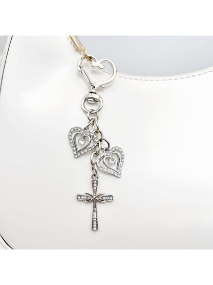 Side view of the vintage cross pendant keychain highlighting its thickness