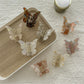 Beau butterfly claw clip held in hand to show size and shape