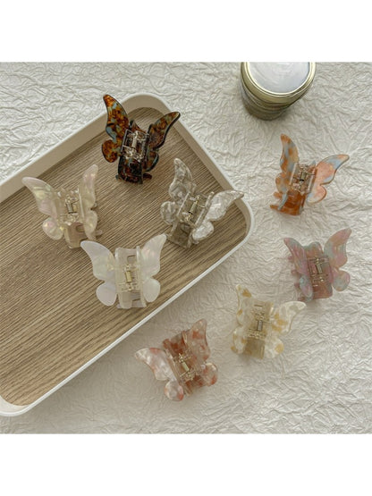 Beau butterfly claw clip held in hand to show size and shape