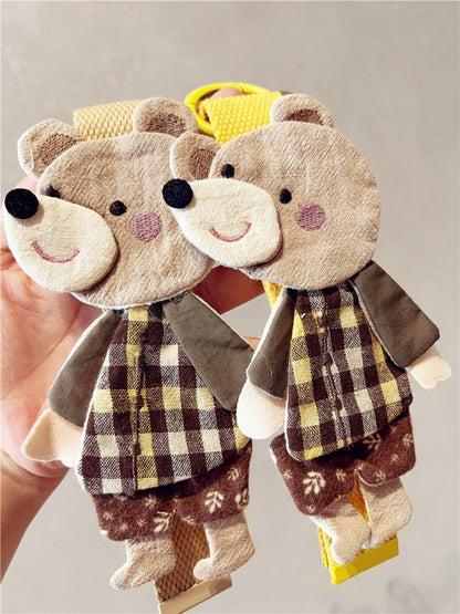 Side view of the fabric patchwork bear keychain highlighting its plush design