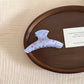 Beau gentle blue hair clip held in hand to show size and shape