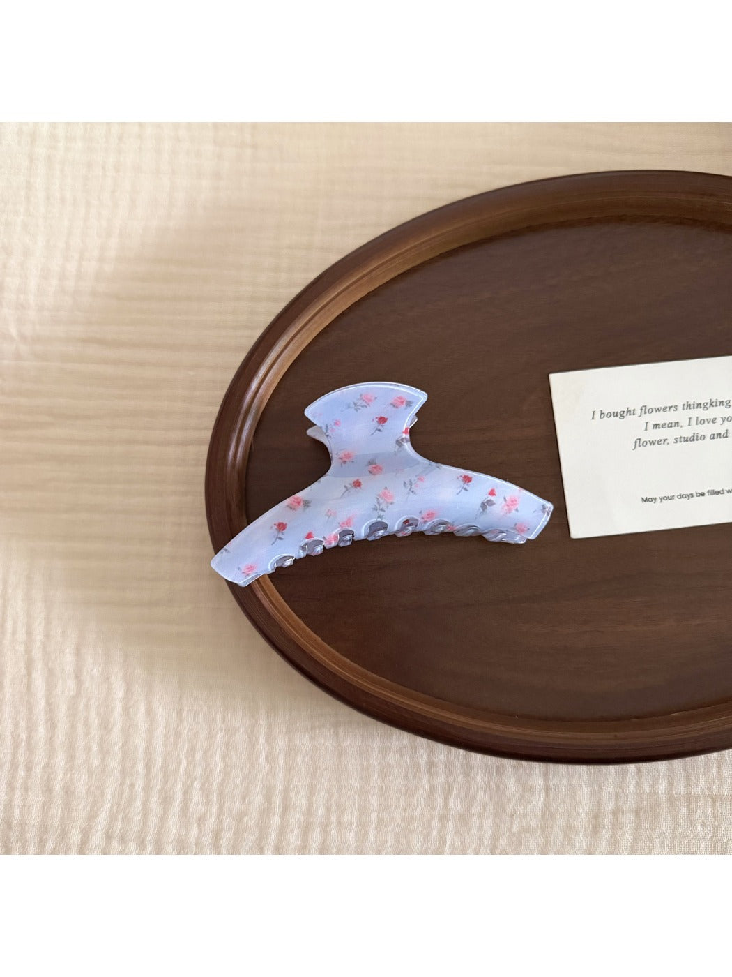 Beau gentle blue hair clip held in hand to show size and shape