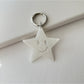 Star pendant keychain with a polished finish reflecting light