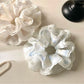 Gifty scrunchie displayed flat highlighting its circular shape and printed design