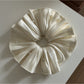 Side view of the satin scrunchie highlighting its gathered design