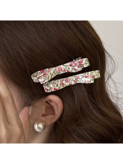 Beau hair clip worn in styled hair, displaying floral design and size