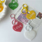 Close-up of red heart-shaped pendant keychain attached to a silver keyring