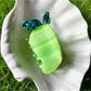 Beau acetate claw clip shaped like a green pear fruit with smooth finish