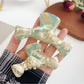 Side view of Beau minimalist bow shaped claw clip highlighting curved design