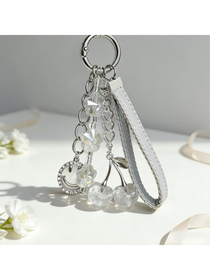 Keypus cherry charm keychain held in hand showing size and detail