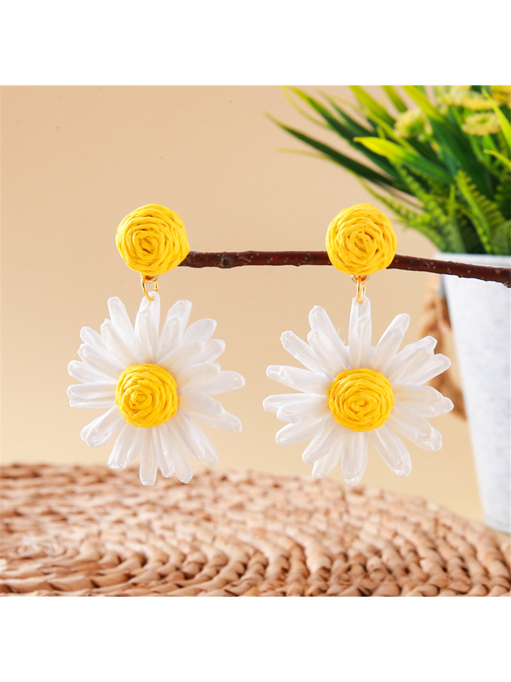 Side view of raffia stud earring showing woven daisy flower design
