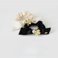 Gifty floral hair tie displayed on a white background showing detailed flower embellishments