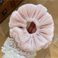 Side view of a ruched satin scrunchie highlighting its elasticity