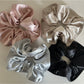 Top view of Gifty satin scrunchie showing smooth, shiny fabric texture